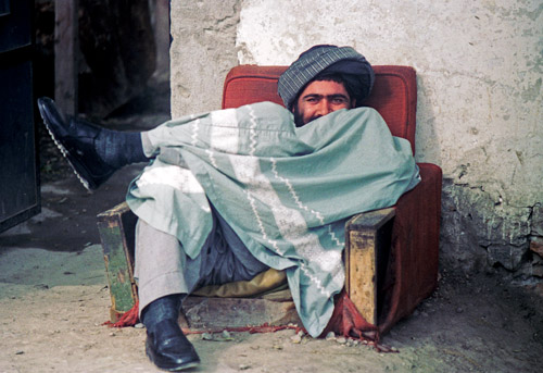 Afghan man in chair in wartorn Kabul